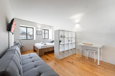 a living room with a couch and a table at GuestReady - Mandariam Studio in Porto