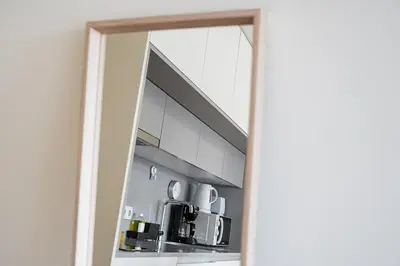 a mirror reflection of a kitchen with a microwave at GuestReady - Mandariam Studio in Porto