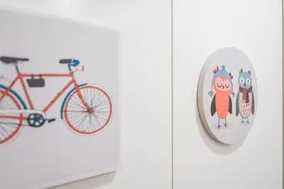 a red bike hanging on a wall next to a clock at GuestReady - Mandariam Studio in Porto