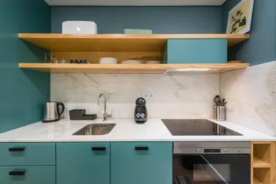 a kitchen with blue cabinets and a sink at GuestReady - Visconde Mezzanine in Porto