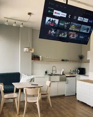 a kitchen with a table and a kitchen with a tv at Trindade Studio by Portomosa in Porto