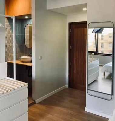 a bathroom with a mirror next to a sink at Trindade Studio by Portomosa in Porto