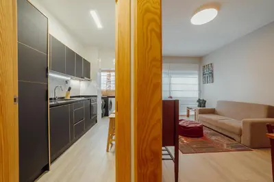 a living room with a couch and a table at Good Morning Torrinha by Vacationy in Porto
