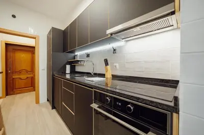 a kitchen with a sink and a stove at Good Morning Torrinha by Vacationy in Porto