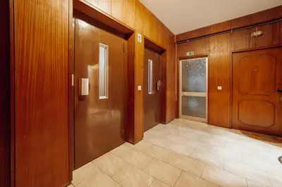 an empty hallway with wooden doors and a tile floor at Good Morning Torrinha by Vacationy in Porto
