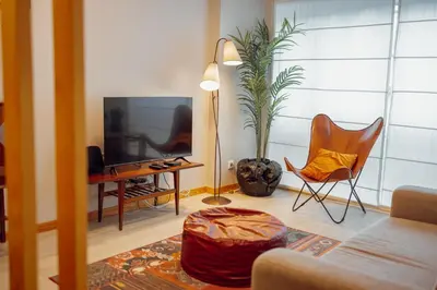 a kitchen and a living room with a couch at Good Morning Torrinha by Vacationy in Porto