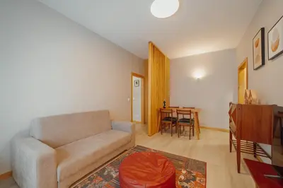 a living room with a couch and a table at Good Morning Torrinha by Vacationy in Porto