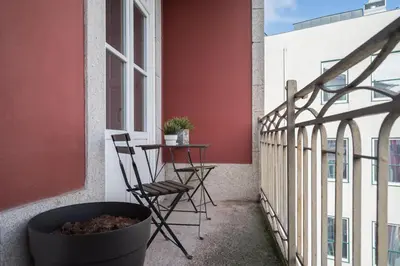 a patio with a table and chairs on a balcony at The Luxe Cube Apartment in Porto