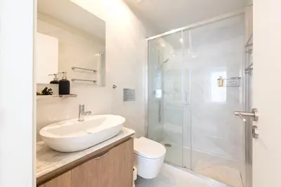 a bathroom with a sink and a shower at Porto Luxe Stay with shared Pool and Garden in Porto