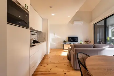 a living room with a couch and a table at Porto Luxe Stay with shared Pool and Garden in Porto