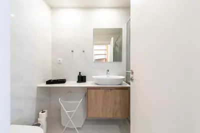 a bathroom with a sink and a mirror at Porto Luxe Stay with shared Pool and Garden in Porto