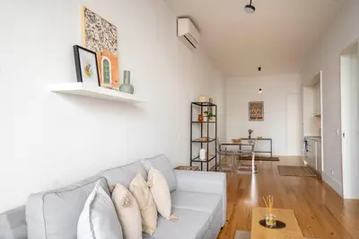 a living room with a couch and a table at Chic 1BR in República w Balcony by LovelyStay in Porto
