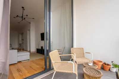 a living room with two chairs and a mirror at Chic 1BR in República w Balcony by LovelyStay in Porto