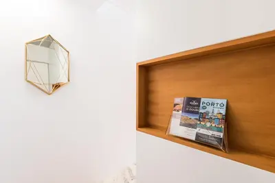 a shelf with a book and a lamp on it at GuestReady - The Citrus Glaze at the Terrace in Porto