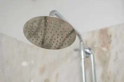 a shower with a shower head in a bathroom at GuestReady - The Citrus Glaze at the Terrace in Porto