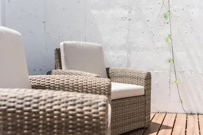 two wicker chairs sitting next to each other in a room at GuestReady - The Citrus Glaze at the Terrace in Porto