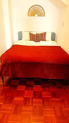 a bed with a red blanket on top of it at Porto Downtown in Porto