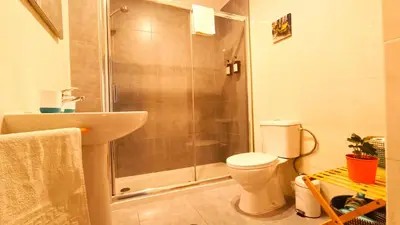 a bathroom with a shower and a toilet and a sink at Porto Downtown in Porto