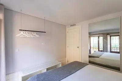 a bedroom with a bed and a mirror at ApartmentsPorto - Rua de Trás 156 in Porto