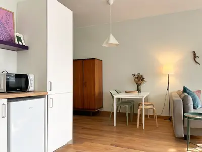 a kitchen and living room with a table and a couch at Casa Sophia in Porto