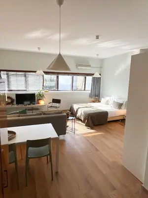 a bedroom with a bed and a living room at Casa Sophia in Porto
