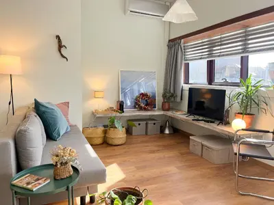 a bedroom with a bed and a chair and a window at Casa Sophia in Porto