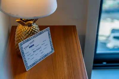 a lamp on a table with a sign on it at Bellevue Oporto Downtown in Porto