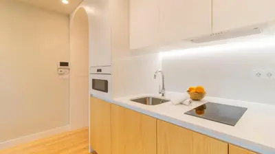 a kitchen with a sink and a counter at Charming apartment frente in Porto