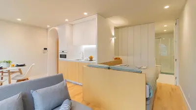 a table with plates and glasses of orange juice at Charming apartment frente in Porto