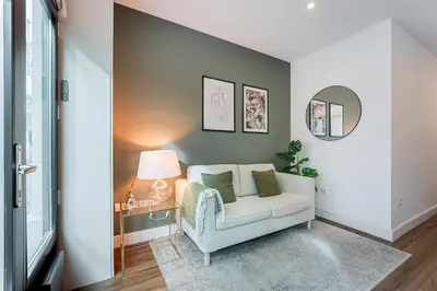 a living room with a chair and a lamp at GuestReady - Restful haven in Porto in Porto