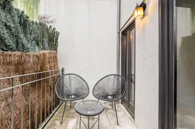 two chairs sitting on a balcony next to a window at GuestReady - Restful haven in Porto in Porto