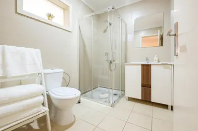 a bathroom with a toilet and a glass shower at GuestReady - Hope Apartments in Porto