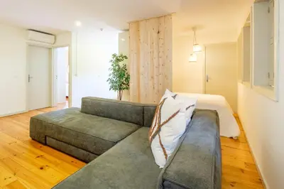 a living room with a gray couch at GuestReady - Hope Apartments in Porto