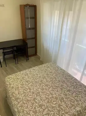 a bedroom with a bed and a desk and a window at Best Stay in Porto in Porto