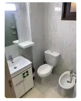 a white bathroom with a toilet and a sink at Best Stay in Porto in Porto
