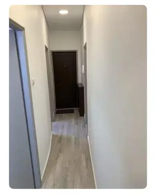 a hallway with a black door and a wooden floor at Best Stay in Porto in Porto