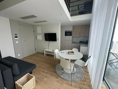 a living room with a white table and chairs at NEW Douro 901 Mezzanini with parking in Vila Nova de Gaia