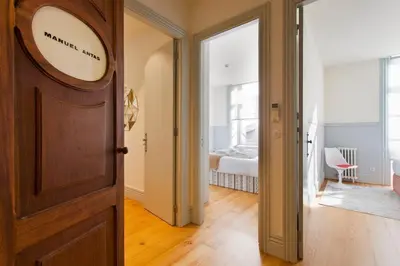 a hallway with a door and a bedroom with a bed at BOUTiQUE Rentals- THE MiRaDOURO Ribeira Apartment in Porto