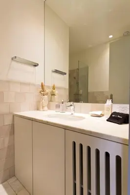 a bathroom with a sink and a mirror at BOUTiQUE Rentals- THE MiRaDOURO Ribeira Apartment in Porto