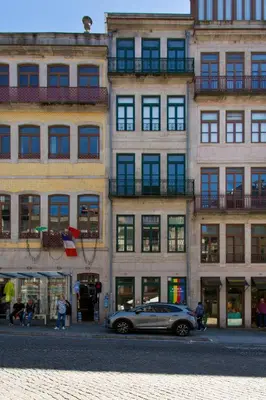 a car parked in front of a tall building at Boutique Rentals-SãO bEnTo Ribeira Apt in Porto