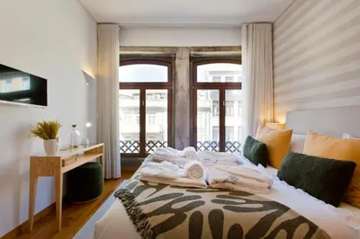 a bedroom with a bed with towels on it at Boutique Rentals-SãO bEnTo Ribeira Apt in Porto