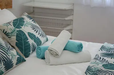 a bed with towels and pillows on it at T3 suites com vistas rio Douro in Vila Nova de Gaia