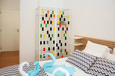 a bedroom with a bed with swans on it at T3 suites com vistas rio Douro in Vila Nova de Gaia