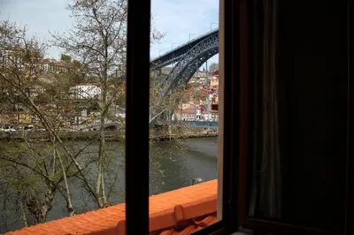 a view of a bridge from a window at T2 suites com vistas rio Douro in Vila Nova de Gaia