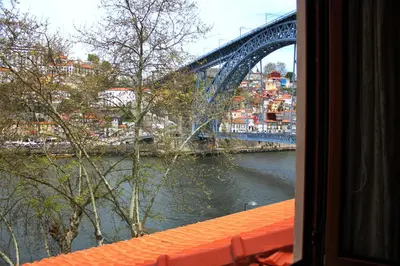 a view of a bridge from a window at T2 suites com vistas rio Douro in Vila Nova de Gaia