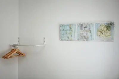 a map and a clipboard on a white refrigerator at T2 suites com vistas rio Douro in Vila Nova de Gaia