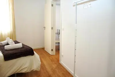 a bedroom with a bed and a sliding glass door at T2 suites com vistas rio Douro in Vila Nova de Gaia