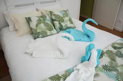 a bed with towels and stuffed animals on it at T2 suites com vistas rio Douro in Vila Nova de Gaia