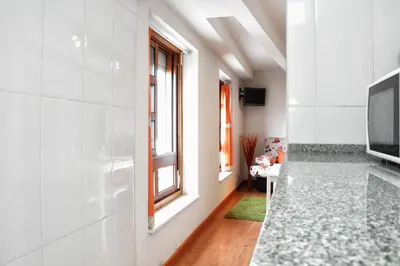 a hallway with a television and a living room at Estúdio com vistas rio Douro in Vila Nova de Gaia