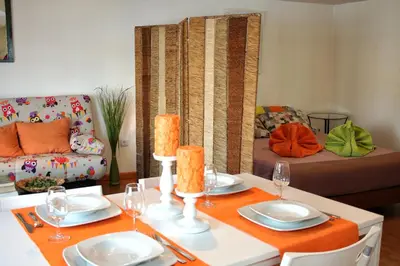 a living room with a table and a couch at Estúdio com vistas rio Douro in Vila Nova de Gaia